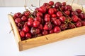 Cherry berries on a wooden tray on a white background Royalty Free Stock Photo