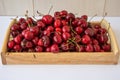 Cherry berries on a wooden tray on a white background Royalty Free Stock Photo