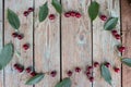 Cherry berry. Harvest cherries on a wooden background. Ripe cherry with green leaves top view