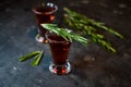 cherry, berry tincture on a dark background, with a sprig of rosemary Royalty Free Stock Photo