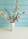 Cherry blossom branch floral decorative vintage beautiful in a vase on a colored wooden background, spring,bouquet Royalty Free Stock Photo
