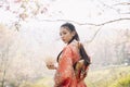 Cherry blossoms and Asian woman wearing kimono. Young girl wearing Japanese kimono standing with Cherry blossoms Royalty Free Stock Photo