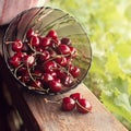 Cherry in a bowl on a wooden background and green blurred square background Royalty Free Stock Photo