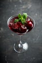 Cherry cocktail in martini glass with berries and mint leaves Royalty Free Stock Photo