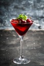 Cherry cocktail in martini glass with berries and mint leaves Royalty Free Stock Photo