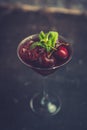 Cherry cocktail in martini glass with berries and mint leaves Royalty Free Stock Photo