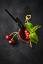 Cherry cocktail with mint in a tall glass on a dark background Royalty Free Stock Photo