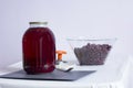 Cherry compote in a glass jar for the winter, preparing food for storage, cherries in a transparent cup