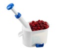 Cherry corer with cherries Royalty Free Stock Photo