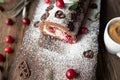 Cherry cream cake rolled up to a swiss roll on wooden background with a cup of coffee Royalty Free Stock Photo