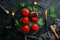 Cherry cream-mousse dessert with cherries and mint on a black stone plate. Top view. Rustic style Royalty Free Stock Photo