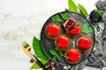 Cherry cream-mousse dessert with cherries and mint on a black stone plate. Top view. Rustic style Royalty Free Stock Photo