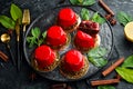 Cherry cream-mousse dessert with cherries and mint on a black stone plate. Top view. Rustic style Royalty Free Stock Photo