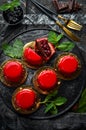 Cherry cream-mousse dessert with cherries and mint on a black stone plate. Top view. Rustic style Royalty Free Stock Photo