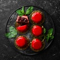 Cherry cream-mousse dessert with cherries and mint on a black stone plate. Top view. Rustic style Royalty Free Stock Photo