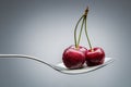 Cherry on curved spoon