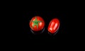 Cherry and datterino tomato on black background fresh biological