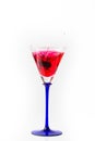 Cherry drop into red wine with splash Royalty Free Stock Photo