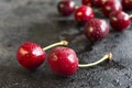 Cherry with drops of water on a black wet surface