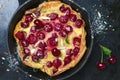 Cherry Dutch Baby, Puff German Pancake on Vintage Pans and Dark Background, Homemade Summer Dessert