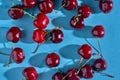 Cherry falls into the cold aqua water surface close up macro