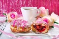 Cherry filled donuts with icing and coffee for valentines Royalty Free Stock Photo