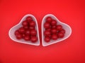 cherry flavored candies in a heart shaped ceramic bowl Royalty Free Stock Photo