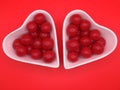 cherry flavored candies in a heart shaped ceramic bowl Royalty Free Stock Photo