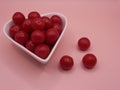 cherry flavored candies in a heart shaped ceramic bowl Royalty Free Stock Photo