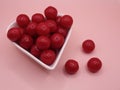 cherry flavored candies in a heart shaped ceramic bowl Royalty Free Stock Photo