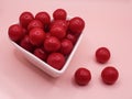 cherry flavored candies in a heart shaped ceramic bowl Royalty Free Stock Photo