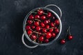 Cherry. Fresh organic sweet cherries in colander on dark stone background Royalty Free Stock Photo