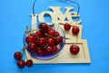 Cherry fresh on a plate love blue background