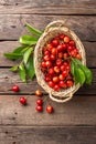 Cherry. Fresh sweet cherry with leaves in basket on wooden table Royalty Free Stock Photo