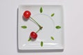 Cherry fruit clock isolated on plate, natural clock