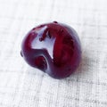 Ripe juicy cherry fruit with water drop on the white linen tablecloth. Red berry on a white background. Royalty Free Stock Photo