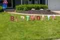 The word BIRTHDAY written in individual colorfully decorated letter signs was seen on a lawn