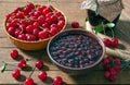 Cherry jam and red cherries in a basket on a wooden table.