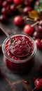 Cherry jam. Spoon scooping homemade cherry jam from a glass jar surrounded by fresh cherries Royalty Free Stock Photo