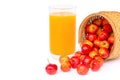 Glass of acerola juice and acerola cherry fruit isolated on white.