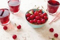 A bowl of fresh cherries and glasses of cherry juice