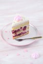 Cherry Layer Cake decorated with fine coconut flakes and colored meringue cookies Royalty Free Stock Photo