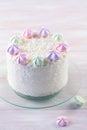 Cherry Layer Cake decorated with fine coconut flakes and colored meringue cookies Royalty Free Stock Photo