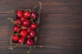 Cherry with leaf on plate and water dropsand on brown stone table Royalty Free Stock Photo