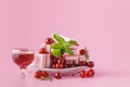 Cherry liquer and sweets on pink background