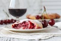 Cherry liqueur in glasses and bowl with fresh cherries Royalty Free Stock Photo
