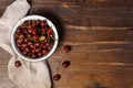 cherry in a metal bowl on a dark wooden background with a linen napkin. horizontal, with space Royalty Free Stock Photo