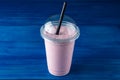 cherry milkshake in plastic glass on a dark background. cherry milkshake in takeaway cup