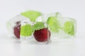 Cherry and mint leaves in ice cubes