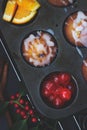 Cherry orange muffins in muffin baking pan; food background Royalty Free Stock Photo